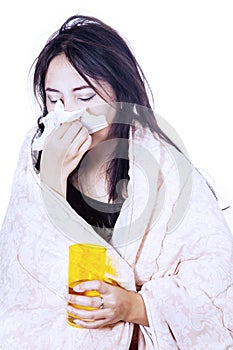 Blowing nose with tissue isolated over white