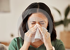 Blowing nose, tissue and woman in a living room with flu, cold and hay fever, crisis or viral infection in her home