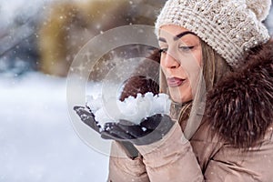 Blowing snow - beautiful girl blowing magic snow. Christmas magi