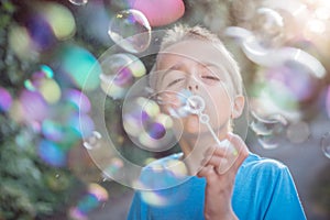 Blowing soap bubbles in the summer sun
