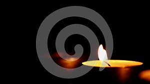 Blown out candles on dark low key background, thirty frame per second, pan shot