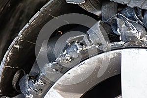 Blown out tire with exploded, shredded and damaged rubber