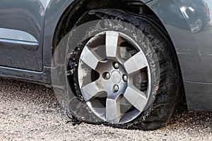 Blown out tire with exploded, shredded and damaged rubber