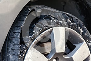 Blown out tire with exploded, shredded and damaged rubber