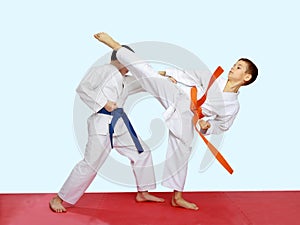 Blows karate are training athletes on a bright and red background