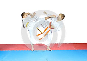 Blows kicks are doing little athletes in karategi photo