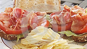 BLT open face sandwich on wheat with chips