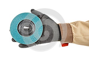 Blue abrasive flap disc for grinding on palm of worker hand in black protective glove and brown uniform isolated on white