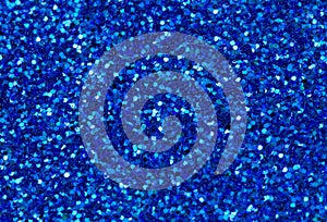 Blue abstract background. Blue glitter closeup photo. Dark blue shimmer wrapping paper.