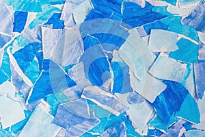 Blue abstract background from torn pieces of paper. Paper collage. Template for graphic design, wallpaper, covers and wrapping