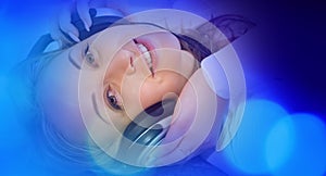 Blue abstract background, young woman in headphones listening to music