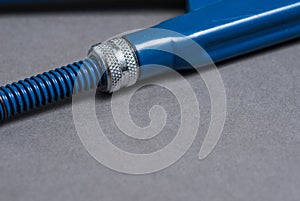 Blue adjustable spanner on grey