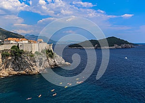 Blue adriatic waters off Croatian coast with kayakers