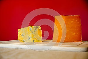 Blue and Aged Red Leicestershire cheese on a cutting board