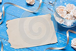 Blue aged wooden table with vintage paper sheet