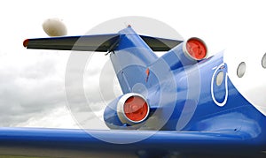 Blue airplane engine, tail and windows