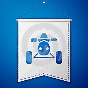 Blue All Terrain Vehicle or ATV motorcycle icon isolated on blue background. Quad bike. Extreme sport. White pennant
