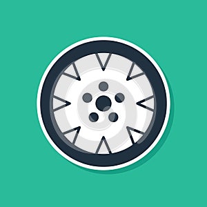 Blue Alloy wheel for a car icon isolated on green background. Vector