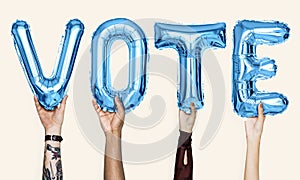 Blue alphabet balloons forming the word vote