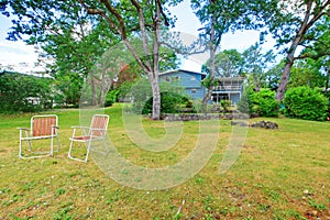 Blue American house exterior with large back yard area.