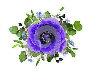 Blue anemone flower, forget-me-not and green leaves in a floral arrangement isolated on white