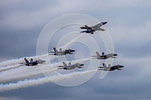 Blue Angels formation planes flying over Houston against a cloudy sky, United States