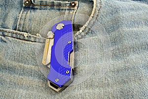 Blue anodized contractors razor knife on jeans