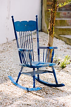 Blue antique rocking chairs on stone porch