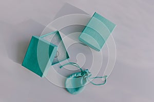 Blue aqua turquoise jewelry boxes. Luxury high end fashion designer accessories. Silver white gold ring. White