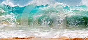 Blue and aquamarine color sea waves and yellow sand  with white foam. Marine beach background.