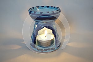 Aroma lamp with a burning candle photo