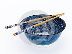 Blue asian porcelain bowl with chopsticks.