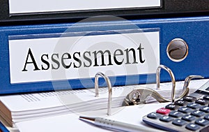 Blue assessment binder in office