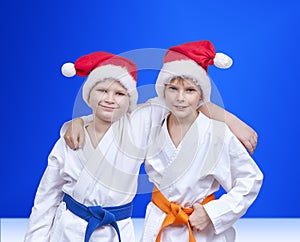 On a blue background boys in caps of Santa Claus
