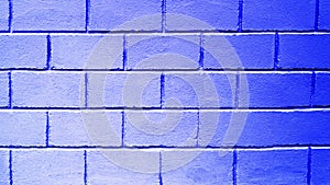 Blue background from brick blocks. Texture of a wall made of large bricks. Copy space. The neon wall is blue
