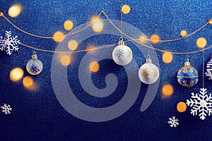 a blue background with christmas ornaments and lights on it and a snowflake on the left side of the frame