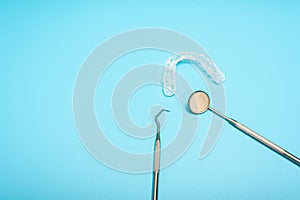 Blue background for dental clinics with dental aligner and mount splints, copy space