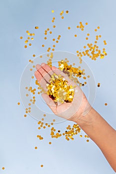 Blue background with golden confetti, selective focus