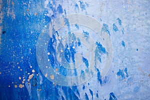 Blue background with ink texture on metal.