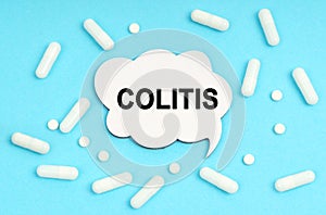 On a blue background pills and a plate. Inside the sign it says - COLITIS