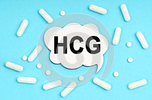 On a blue background pills and a plate. Inside the sign it says - HCG