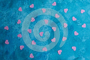 a blue background with pink hearts scattered on it