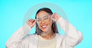 Blue background, smile and face of a woman with glasses for vision, cool eyewear and eye care. Happy, trendy and