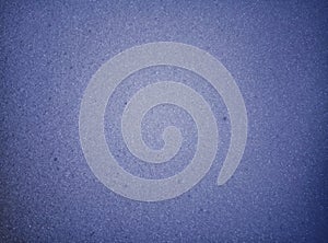 Blue background surface texture of a glowing sponge foam