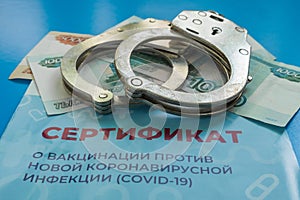On the blue background there is money, handcuffs and a certificate of inoculation from Covid-19. Punishment for breaking