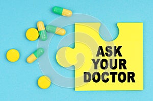 On a blue background, there are pills and a puzzle with the inscription - ASK YOUR DOCTOR