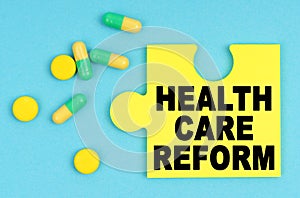 On a blue background, there are pills and a puzzle with the inscription - HEALTH CARE REFORM