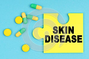 On a blue background, there are pills and a puzzle with the inscription - SKIN DISEASE