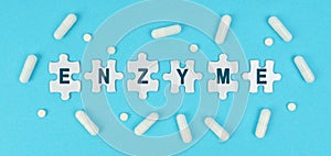 On a blue background, there are pills and puzzles with the inscription - ENZYME