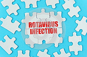 On a blue background are white puzzles with the inscription -Rotavirus infection